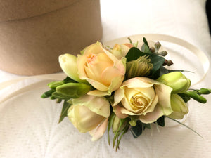wrist corsage cream roses freesia by North Shore florist 